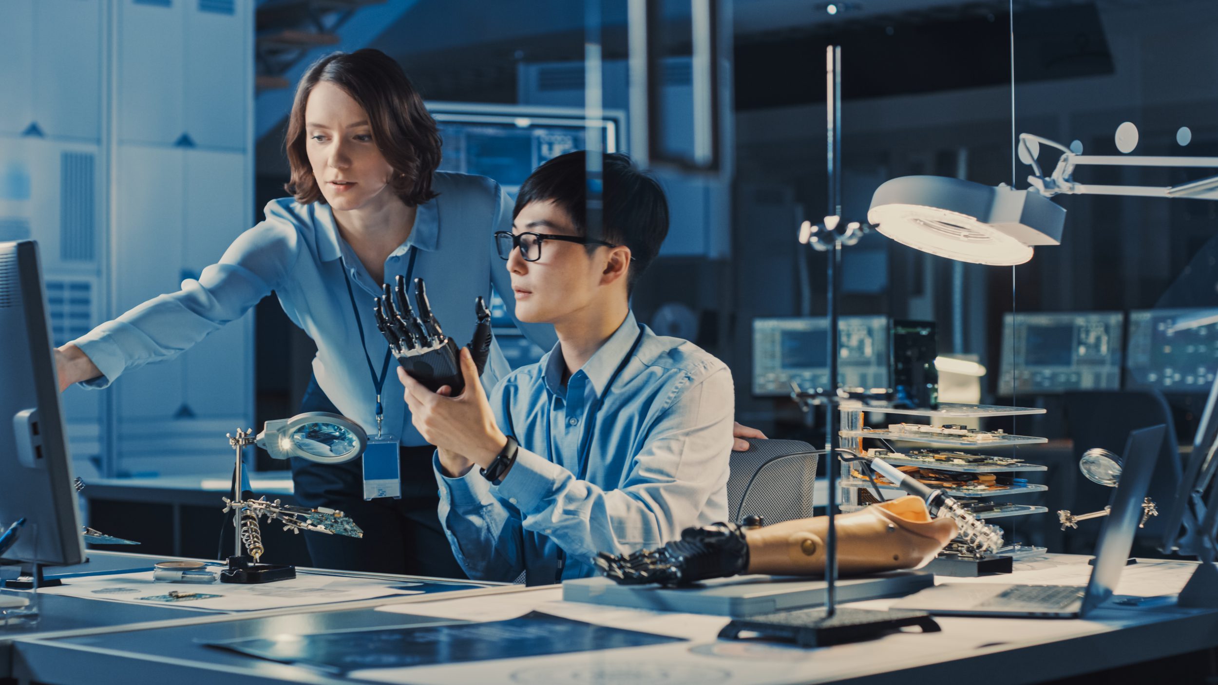 Technological Prosthetic Robot Arm is Tested by Two Professional Development Engineers in a High Tech Research Laboratory with Modern Futuristic medical device to be government ready